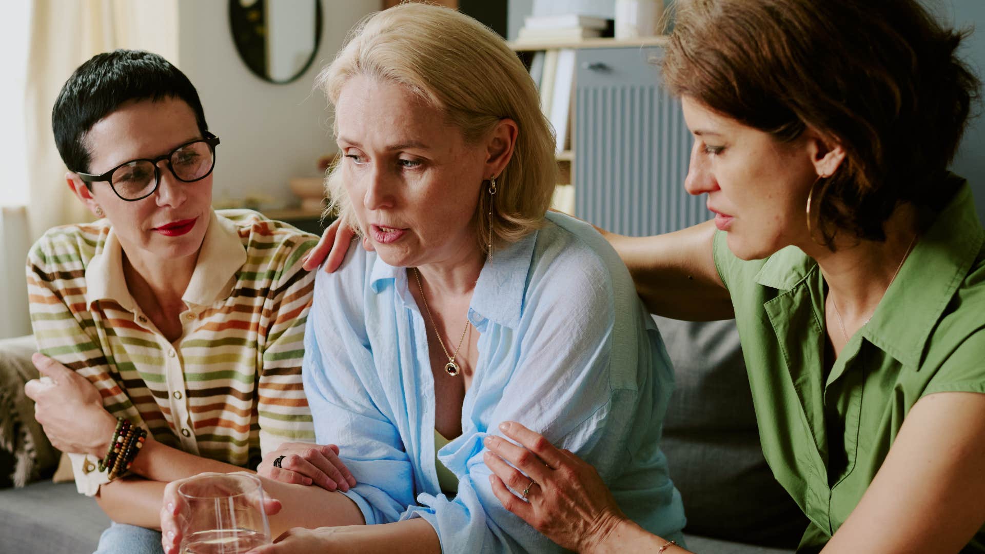 Woman who subconsciously defends you sitting with friends.