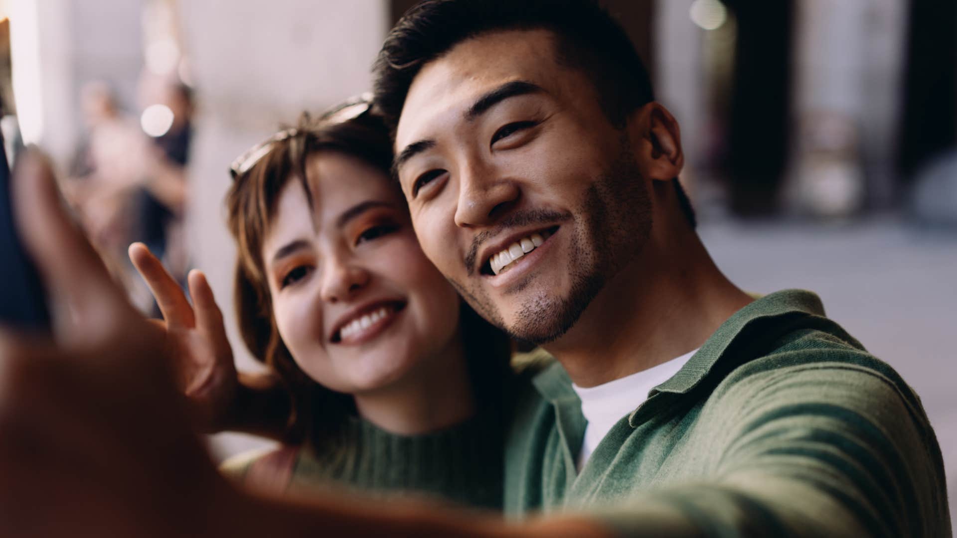 couple taking a selfie after man spoke kindly about wife