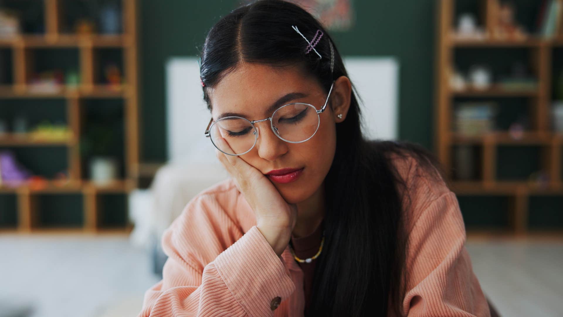 gen z woman sitting inside instead of spending time outdoors