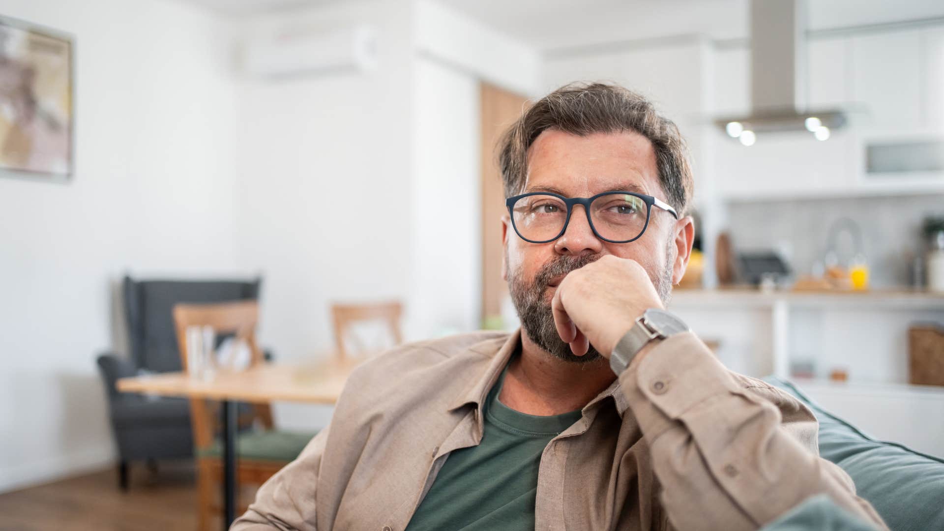 serious retired man relaxing on couch giving himself permission to rest
