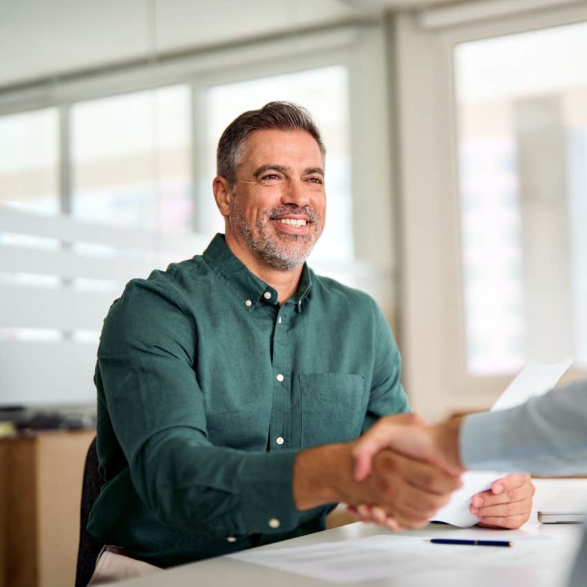 man shaking hands in job interview answering salary question