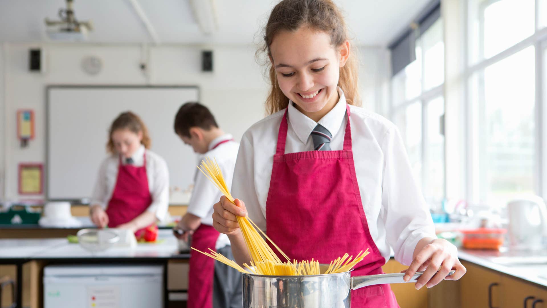 teenage girl smiling in a home economics class