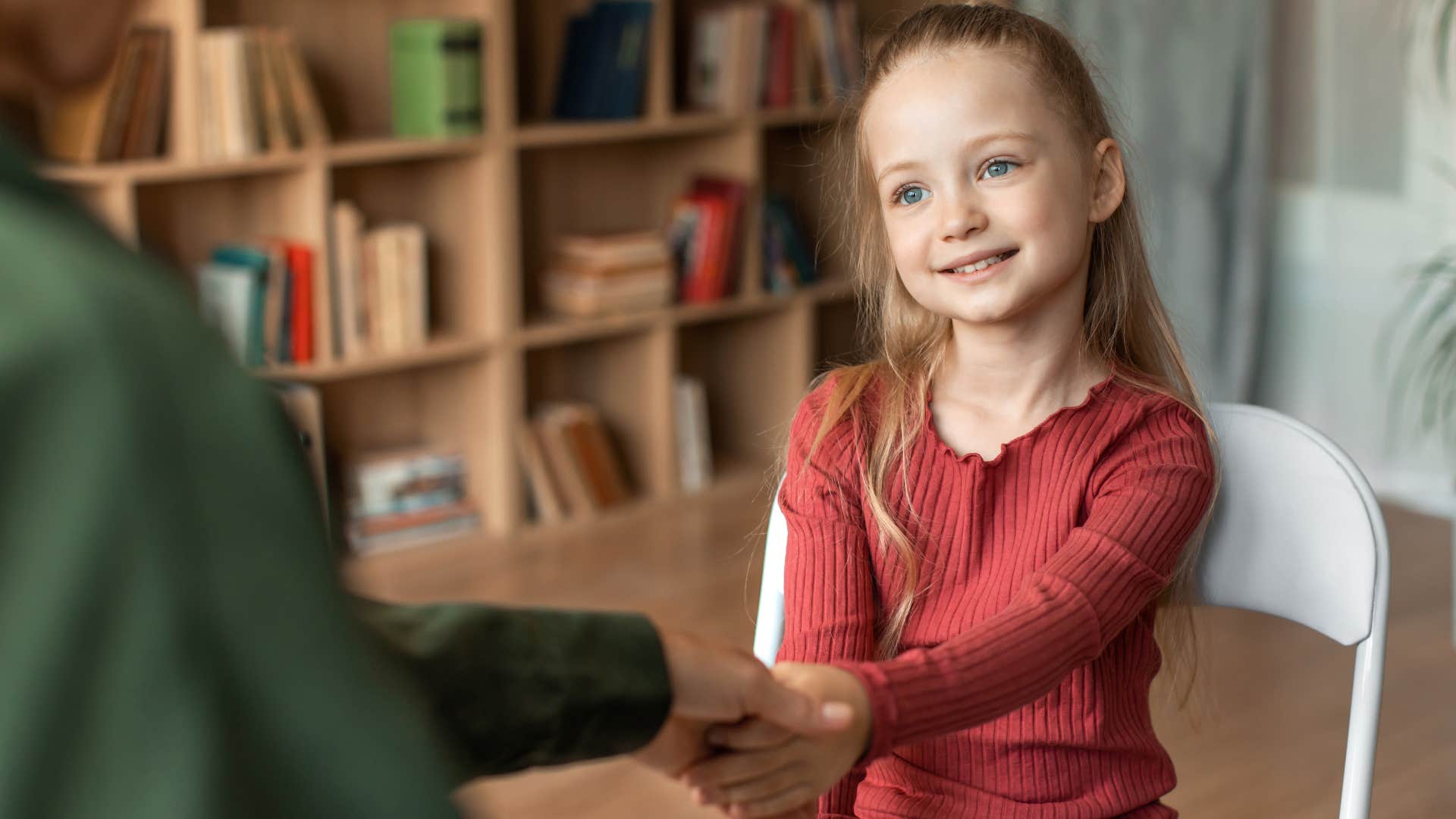 little girl practicing job interview etiquette at school