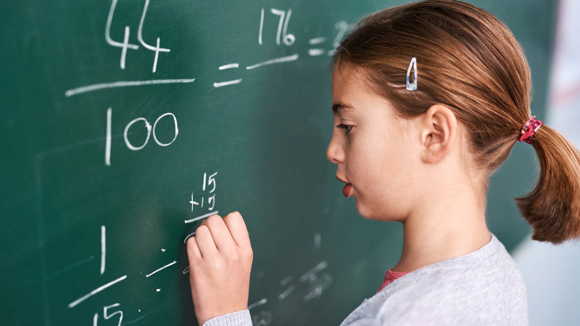 little girl doing long-form mathematics at school
