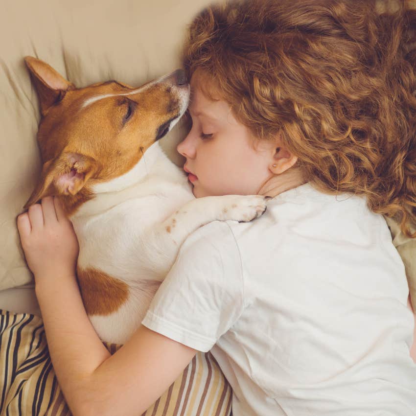 little girl with strong immune system after sleeping in bed with dog