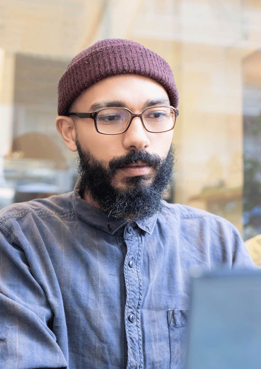 serious man focused on laptop screen