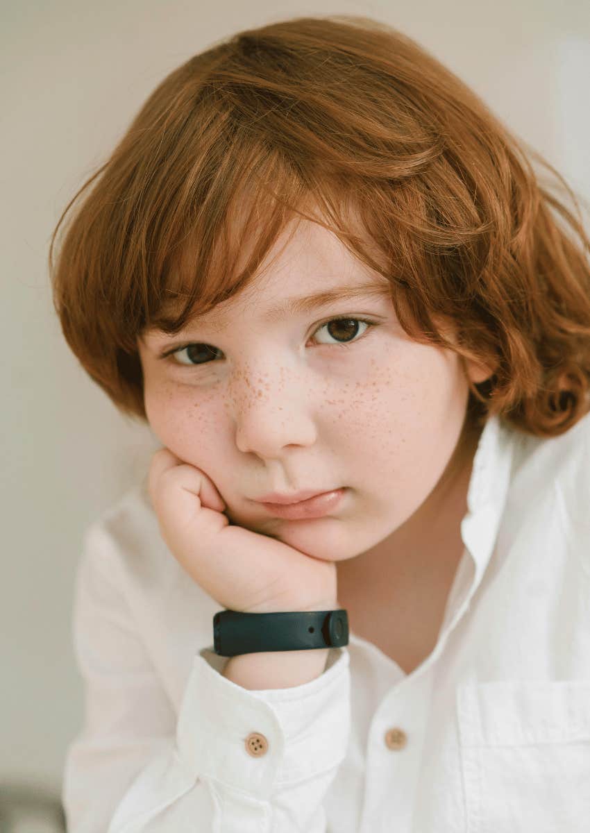 serious young boy facing the world's demands