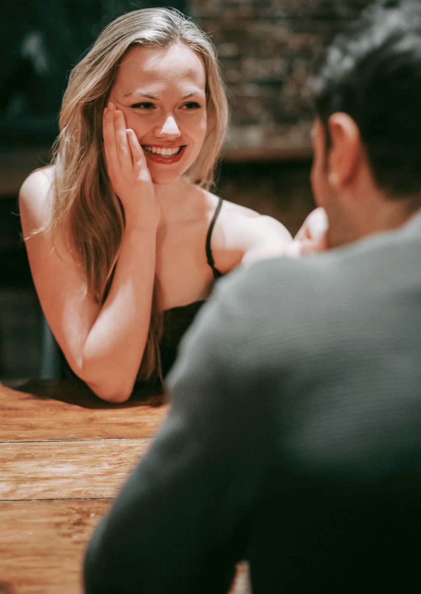 shy woman smiling at compliment from man