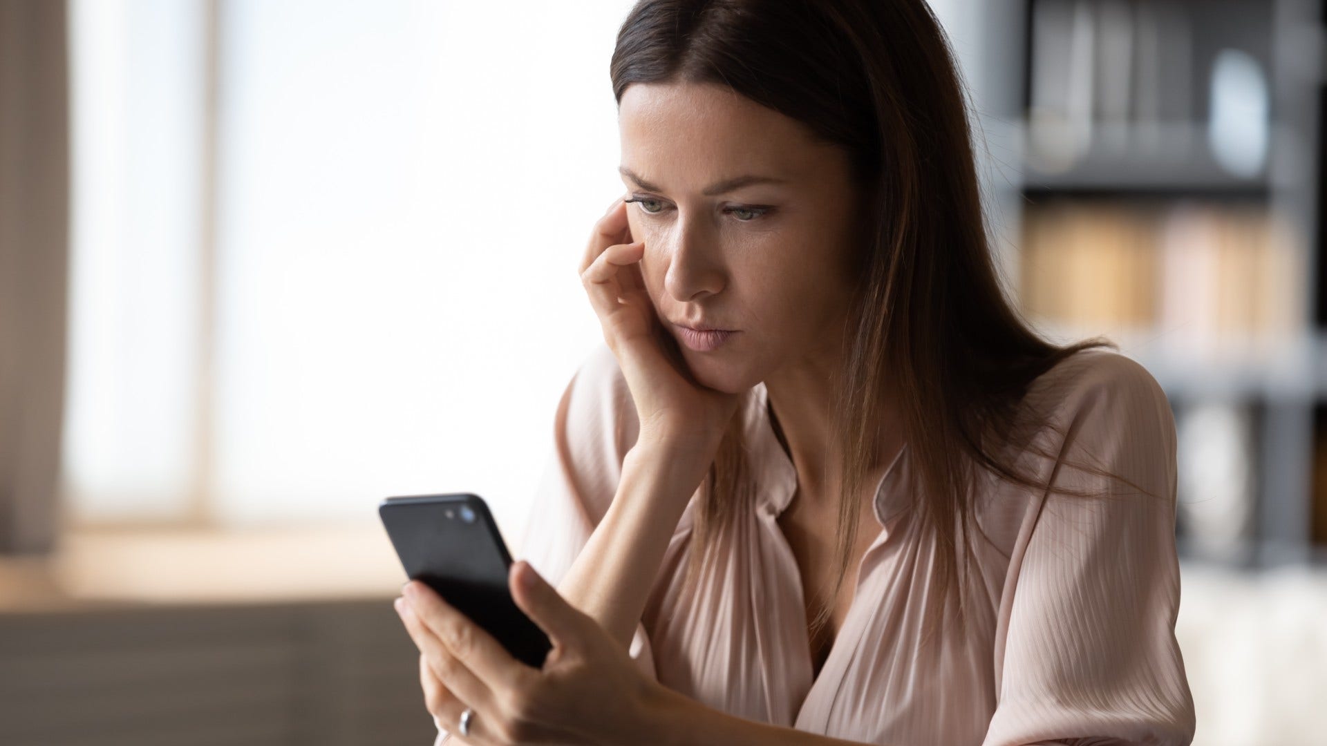 woman who is being tested by someone delaying responses strategically