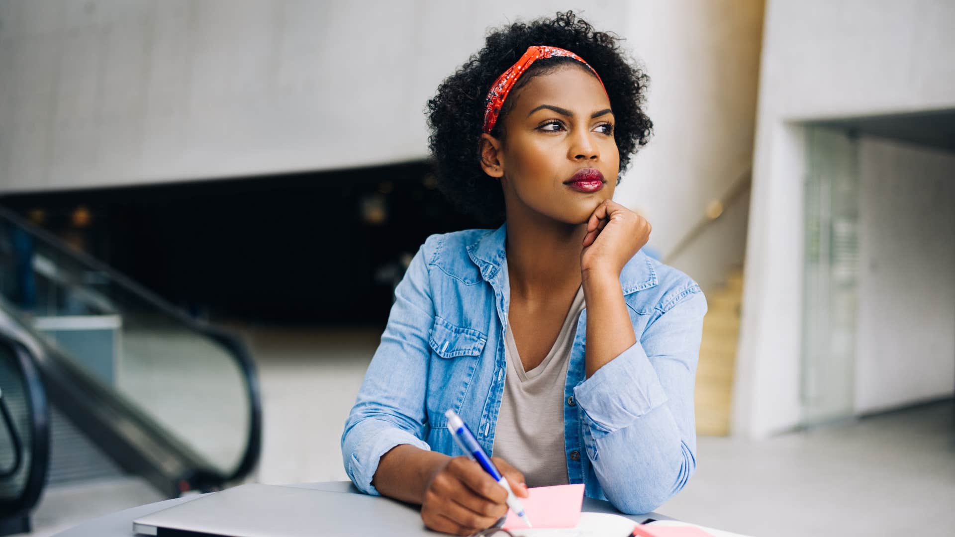 Woman thinking deeply at an outdoor table