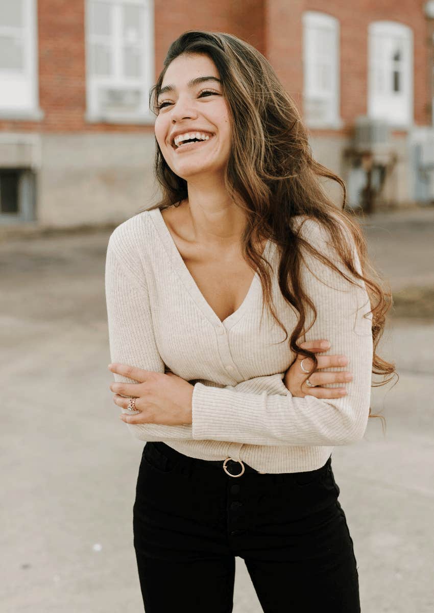 single smiling woman part of the happiest group of people