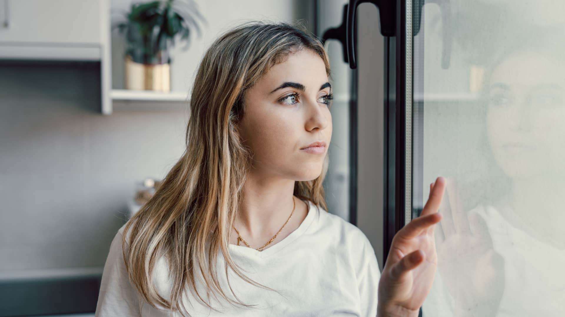 single woman looking out the window waiting for the right person