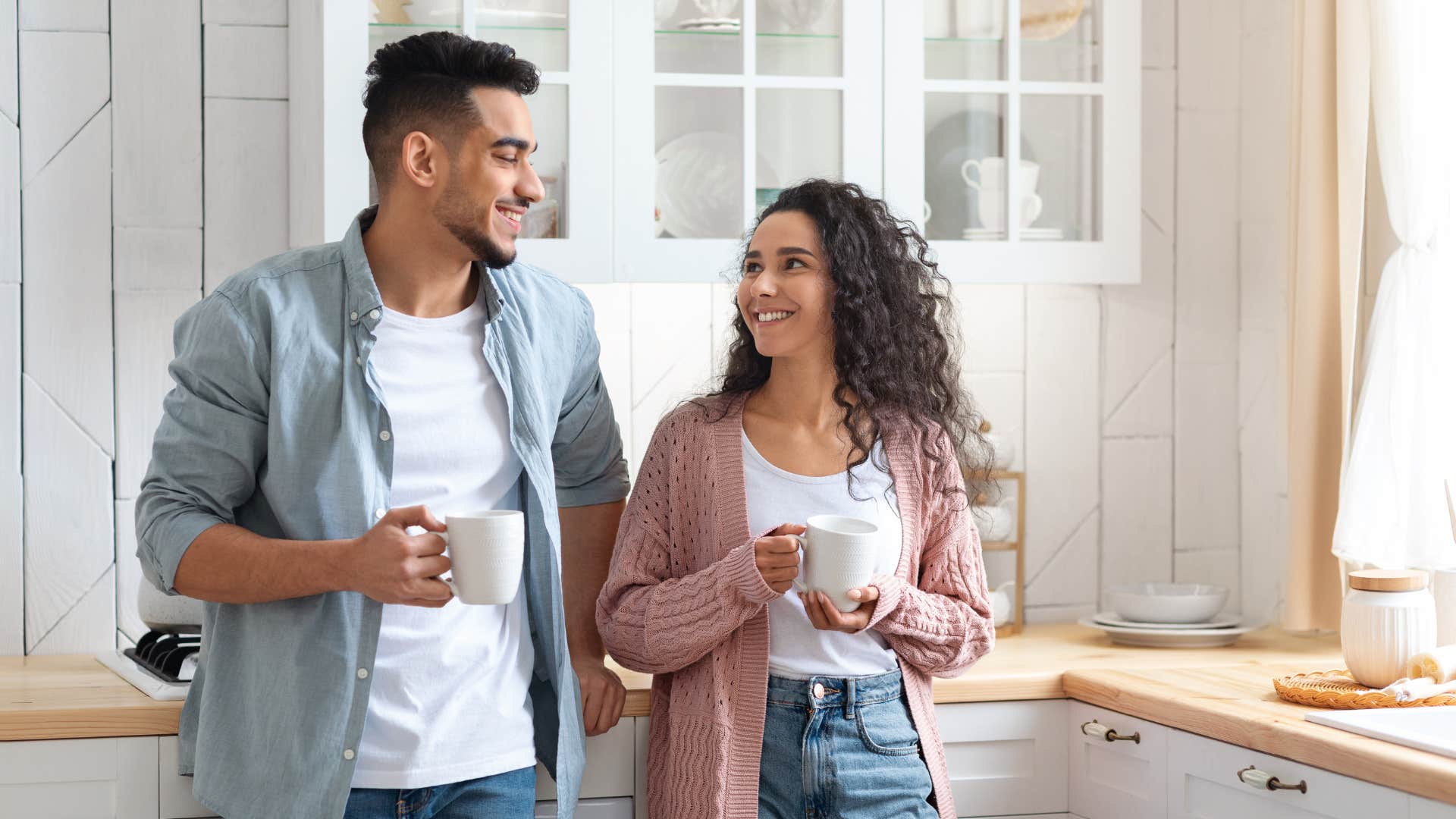 couple with shared values smiling in kitchen together