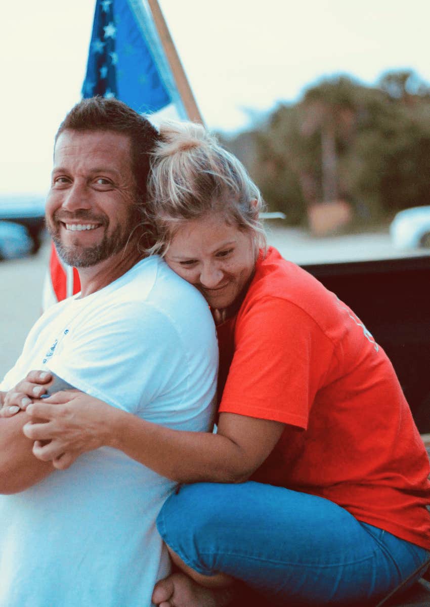 smiling couple hugging outdoors
