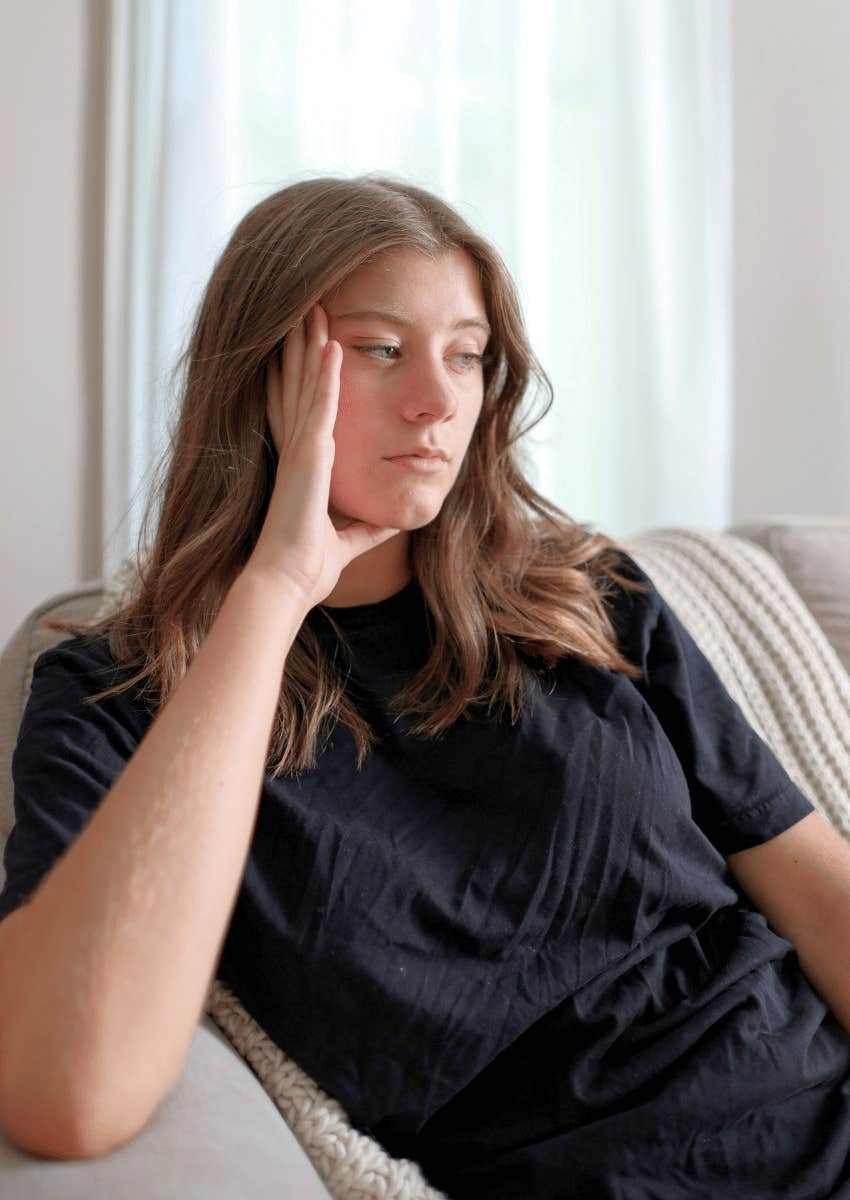 solemn young woman sitting alone