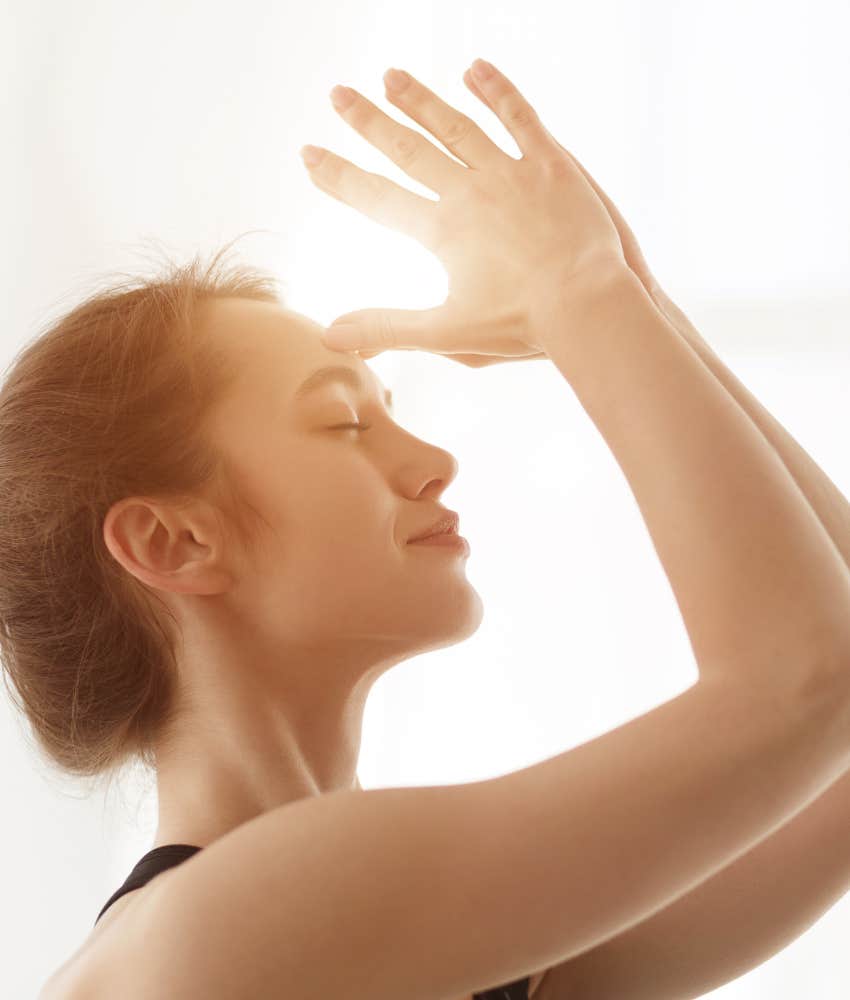 Curious person with hands raised to forehead showing spiritual difference 