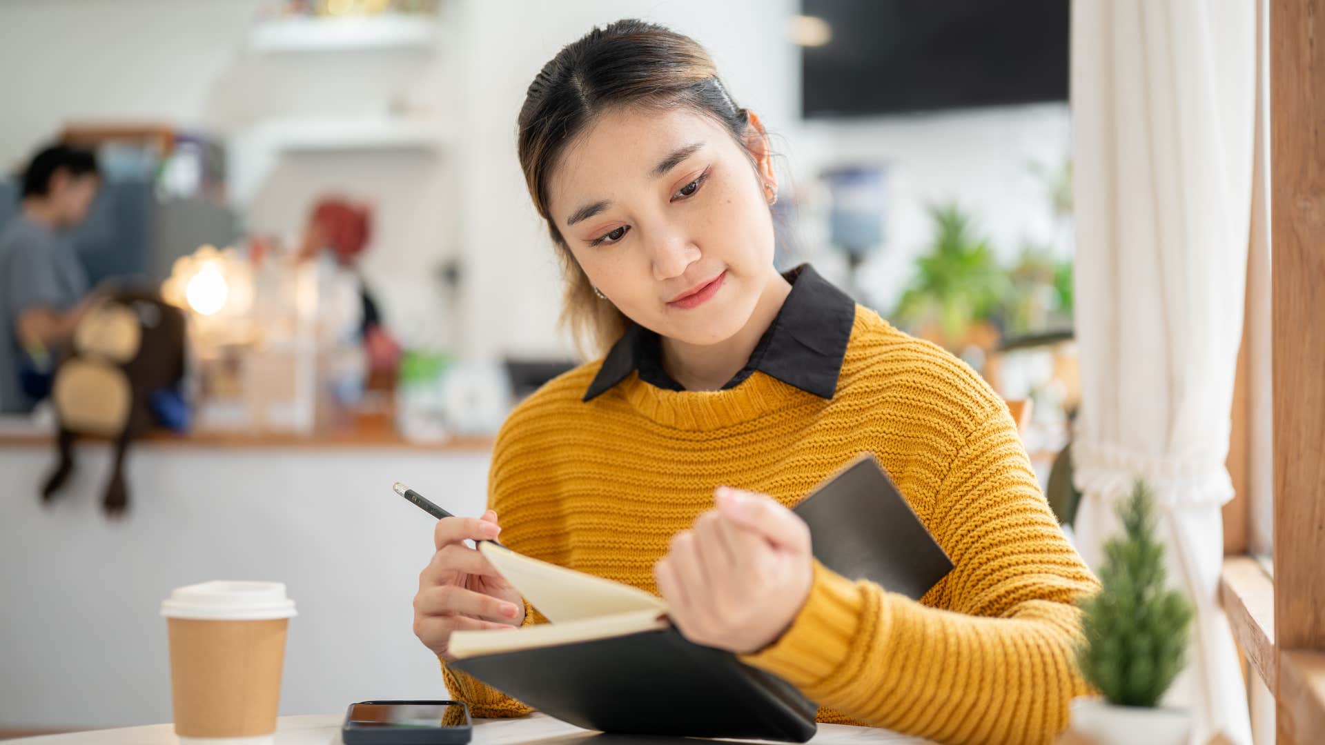woman in yellow shirt working with background noises