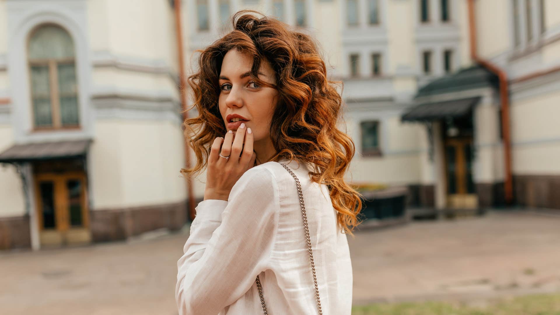 Flirty woman touches lips showing way to attract men