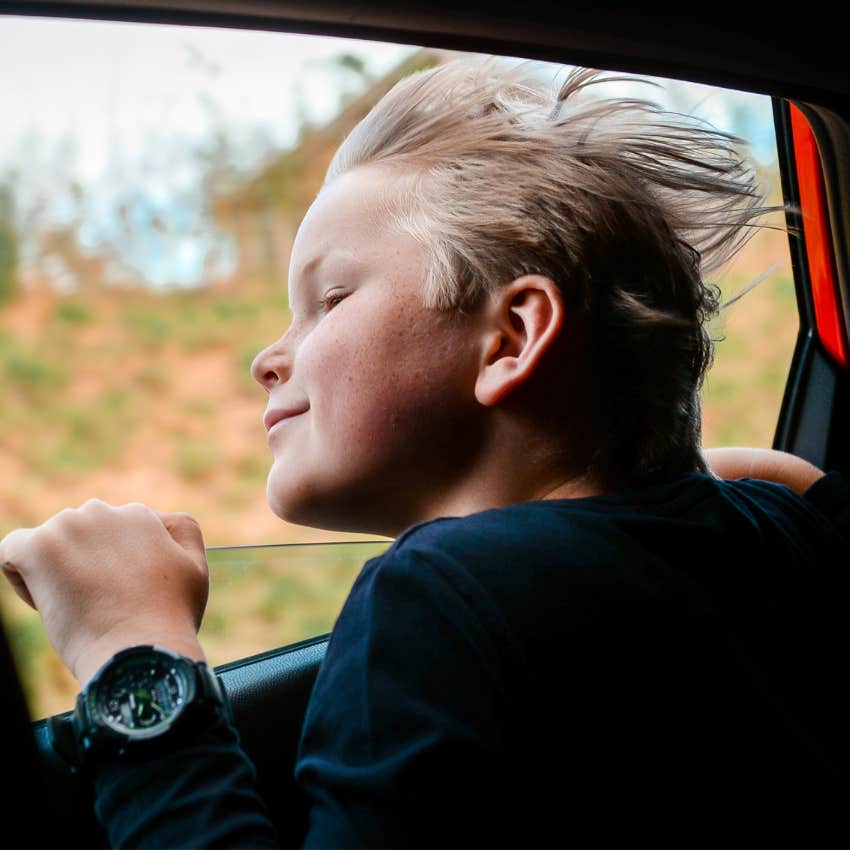 Little boy riding in a car without a seatbelt