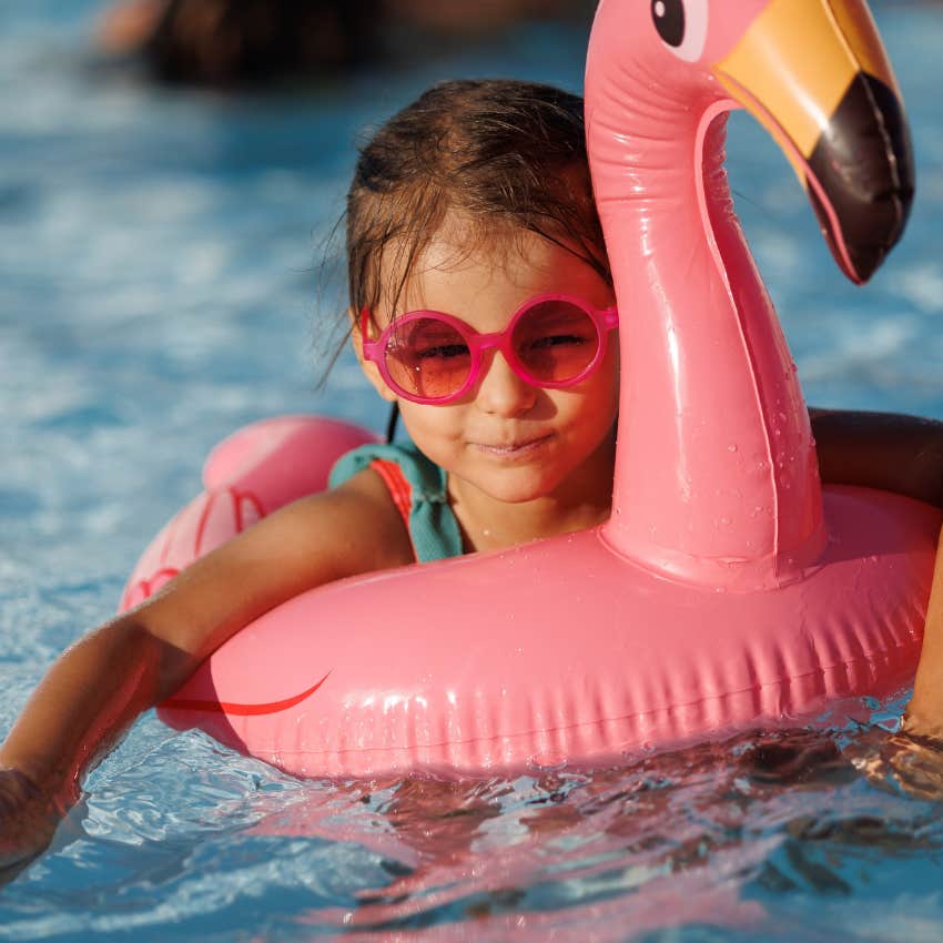 Little girl swimming in neighborhood pool without supervision like kids in the 1970s used to do