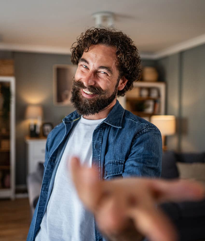 Smiling man reaches out in humor showing lack of respect