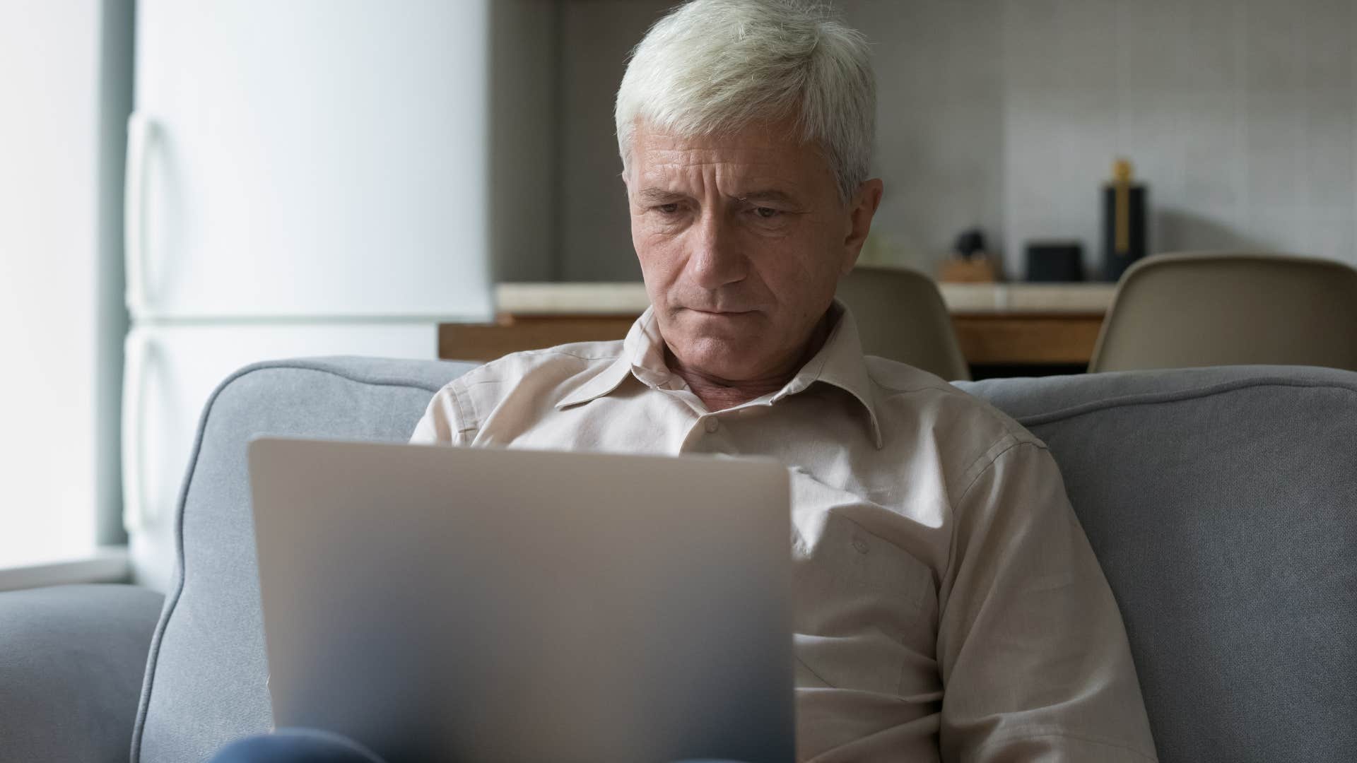 elderly man on computer overusing all caps in his emails online