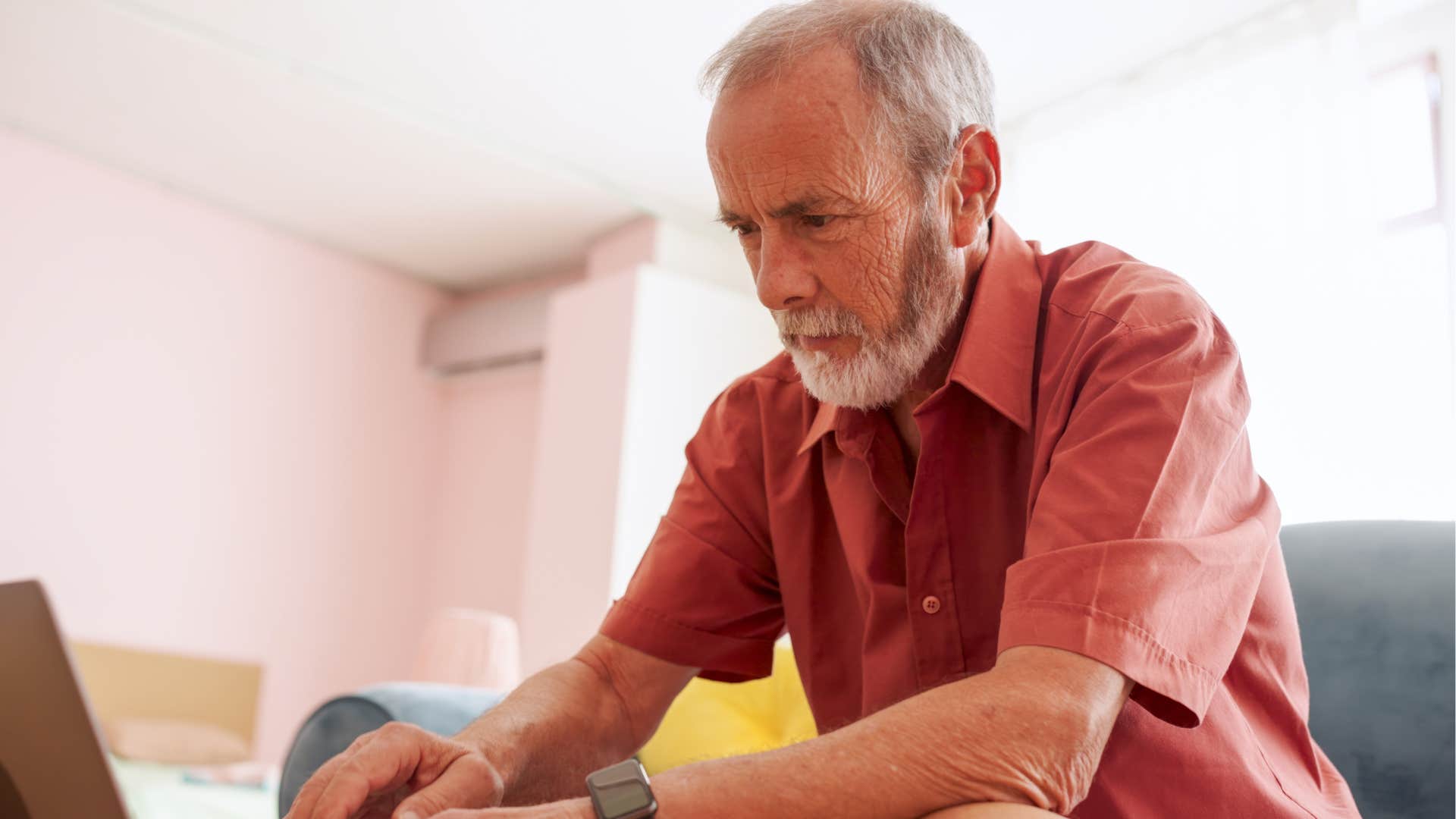 older man signing off with all his credentials on his computer