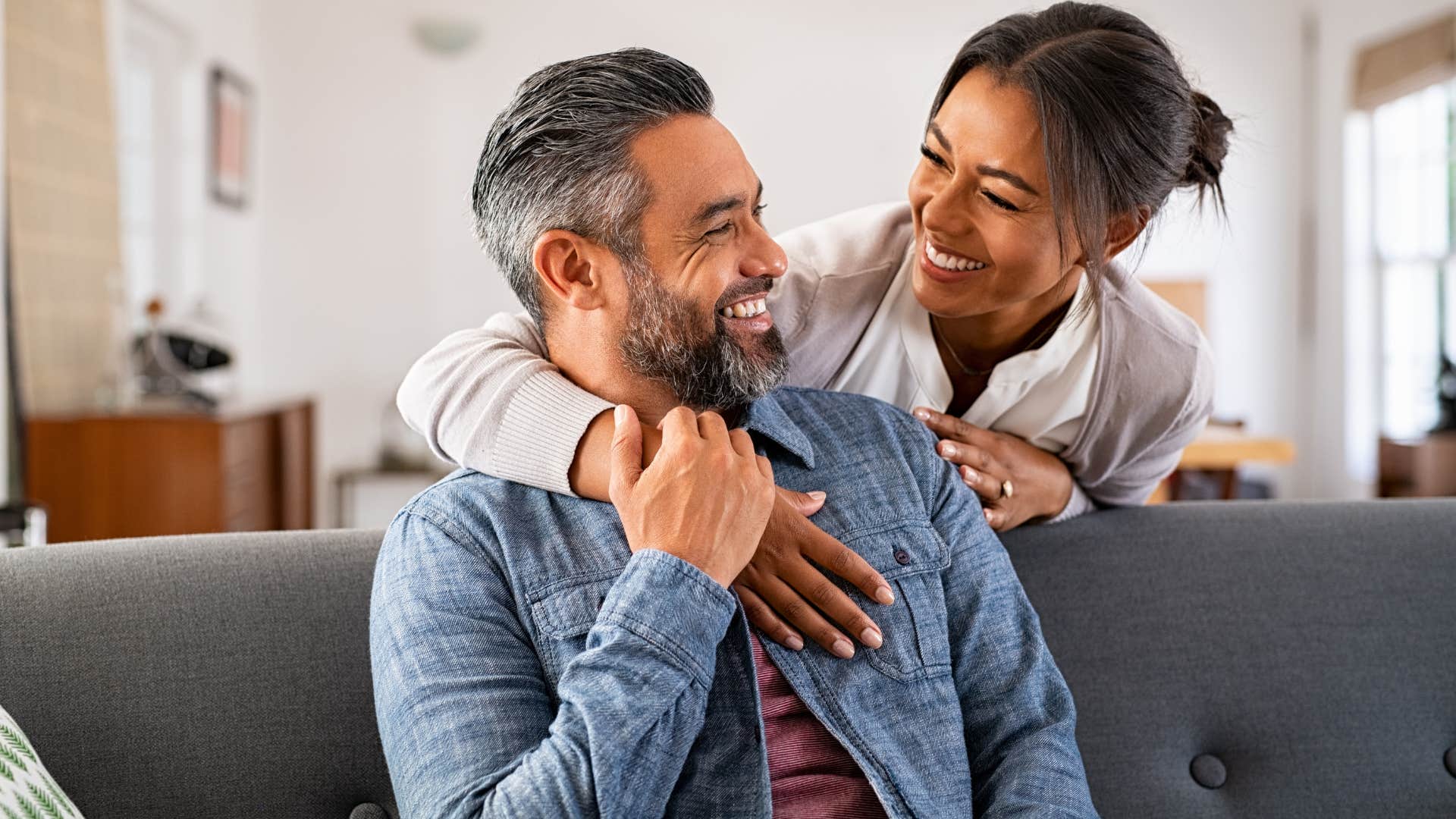 Man who's not performative smiling with his wife.