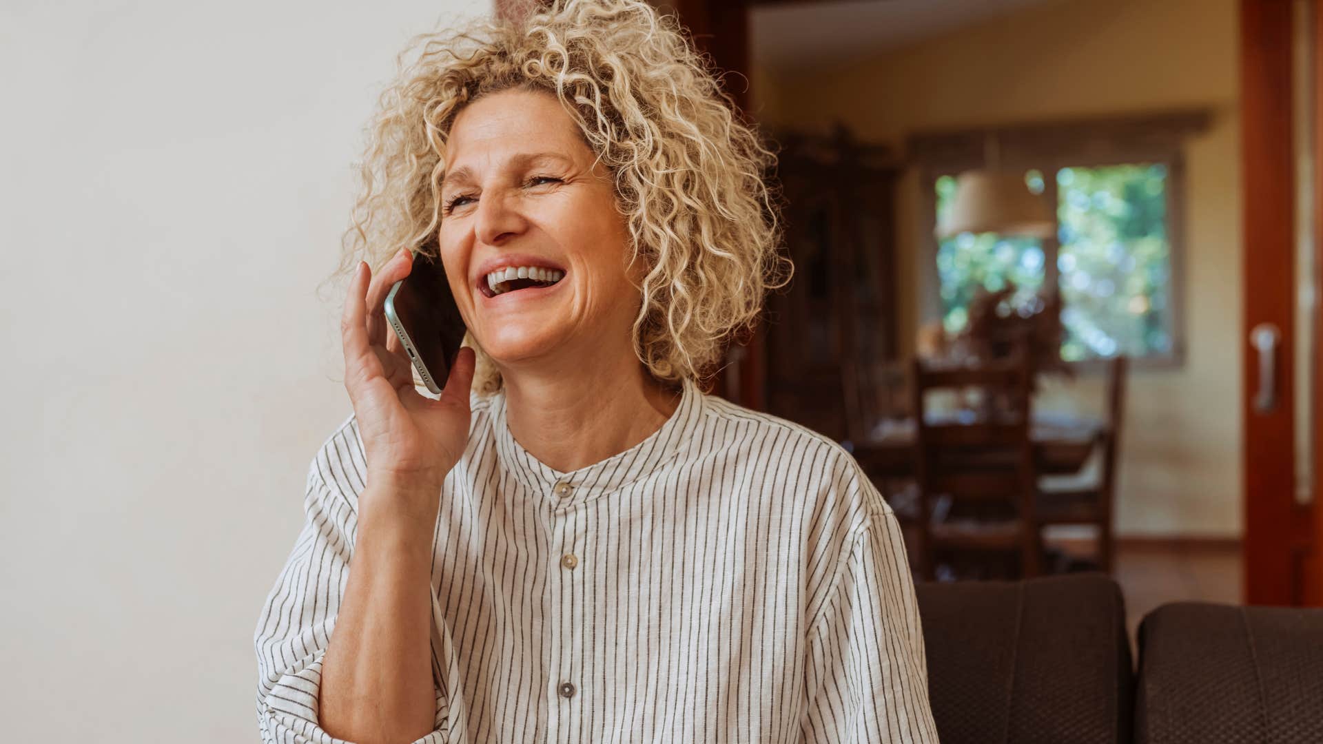 authentic woman talking on the phone happy