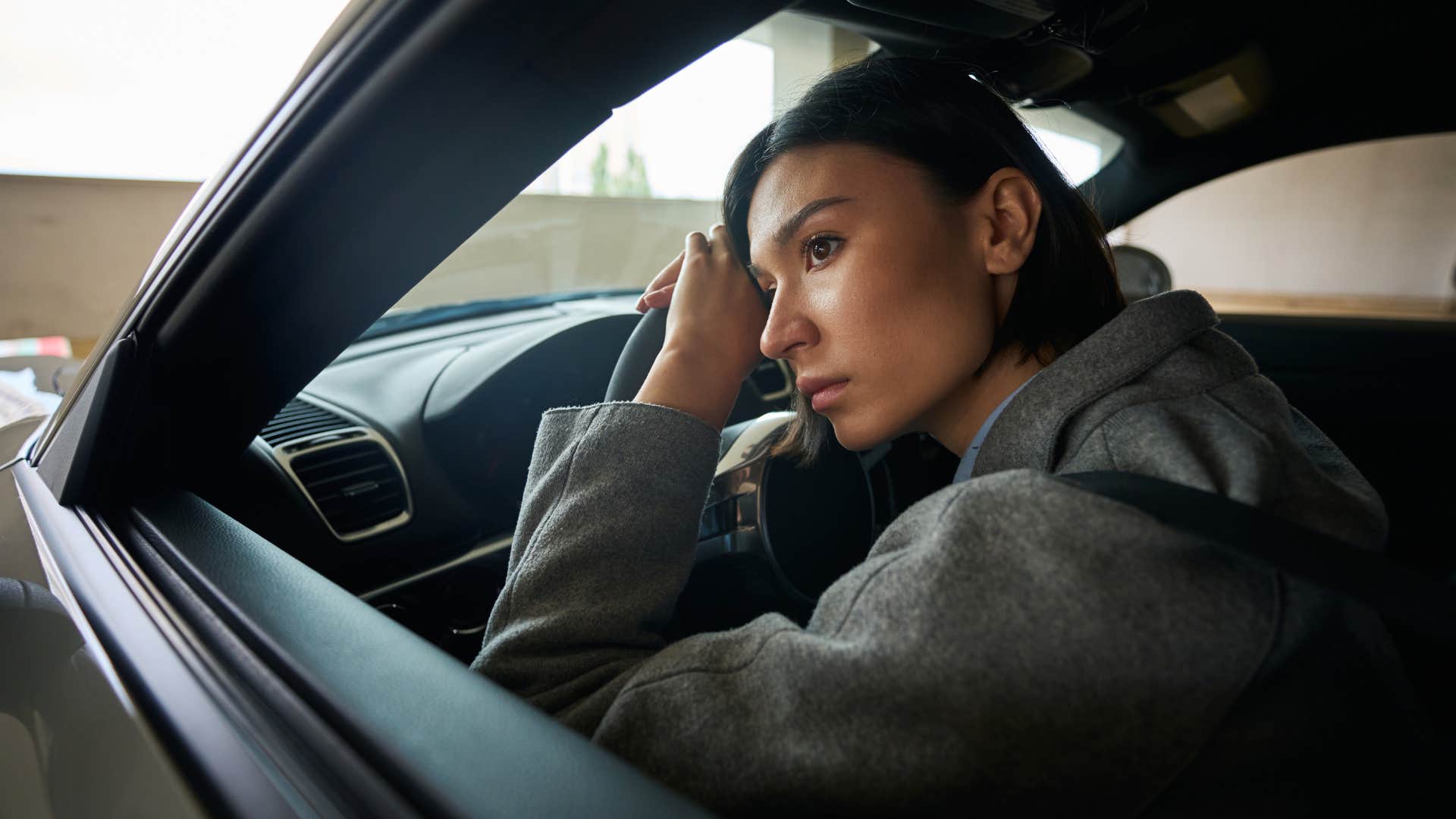 highly sensitive woman in her car drained by passive-aggressive comments
