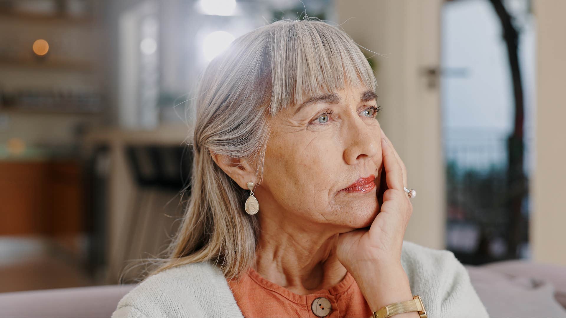 Introspective person touches chin showing deep memories