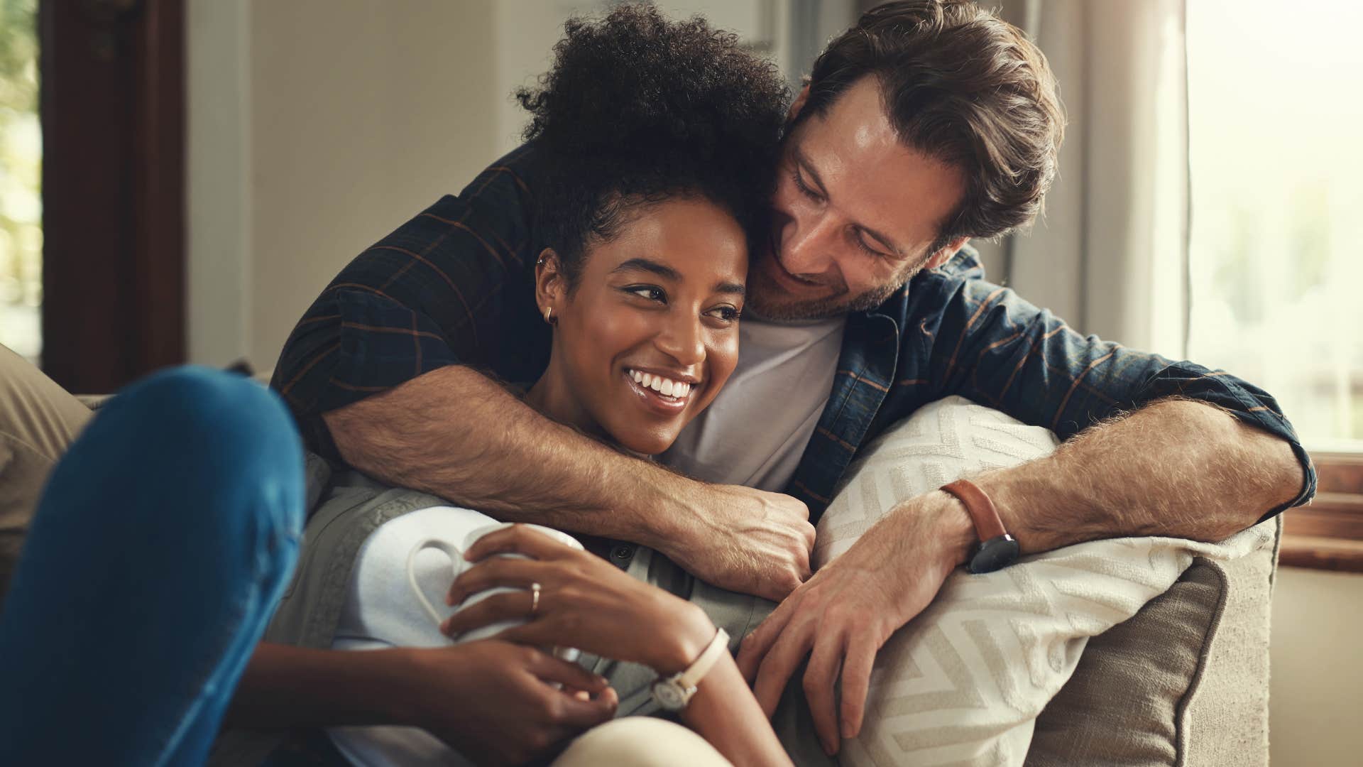 wife cuddling with man who doesn't keep score in the marriage