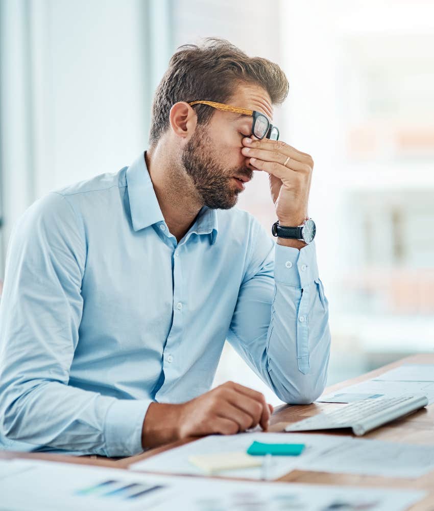 man stressed while working at office