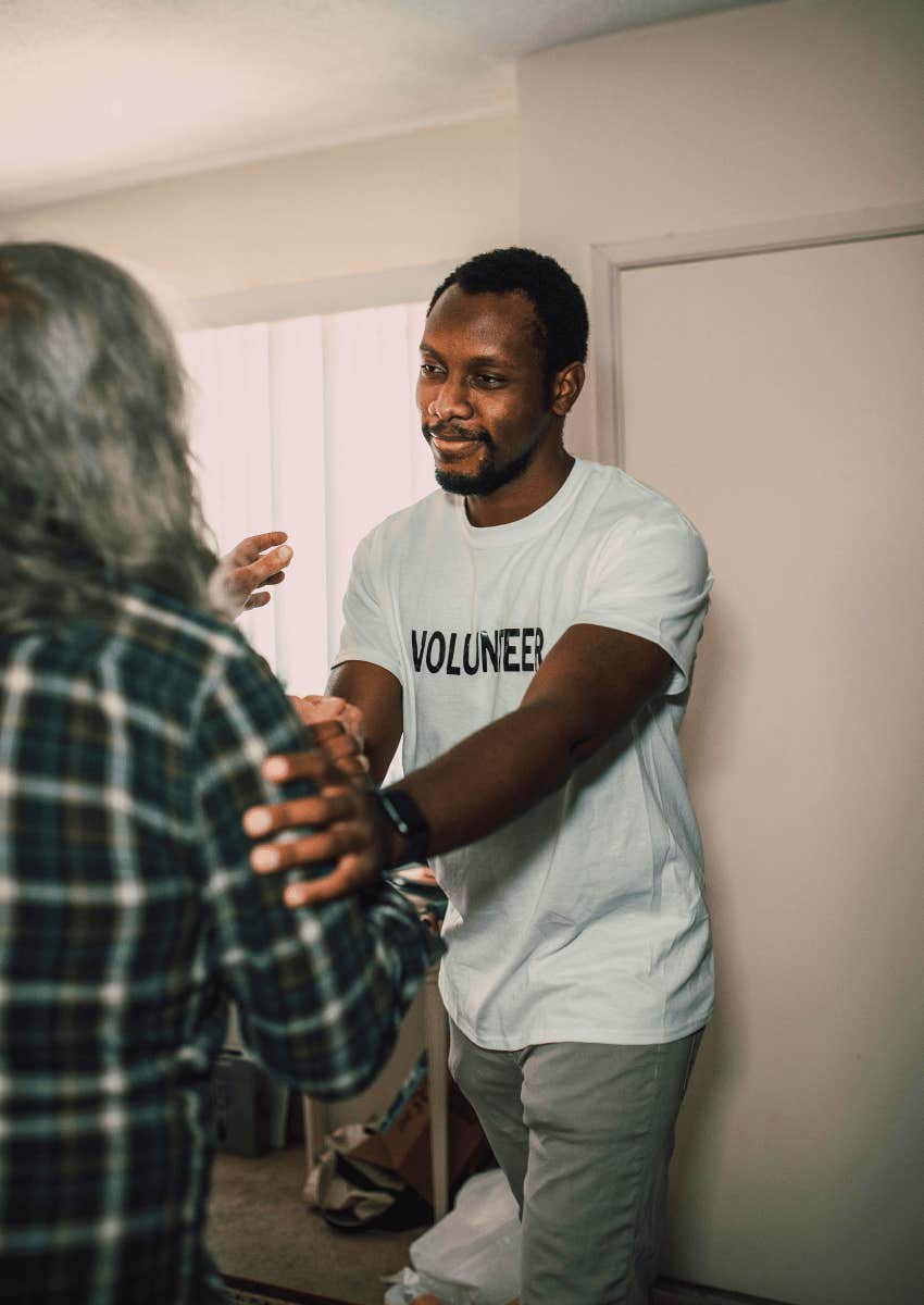 volunteer greeting community member warmly