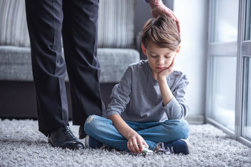 sad child with dad dressed for work