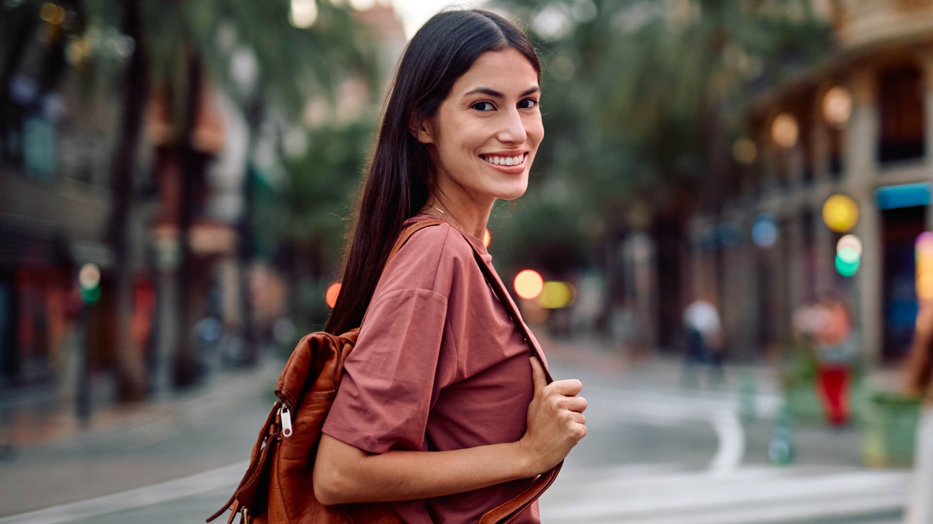 self-aware woman smiling walking outside