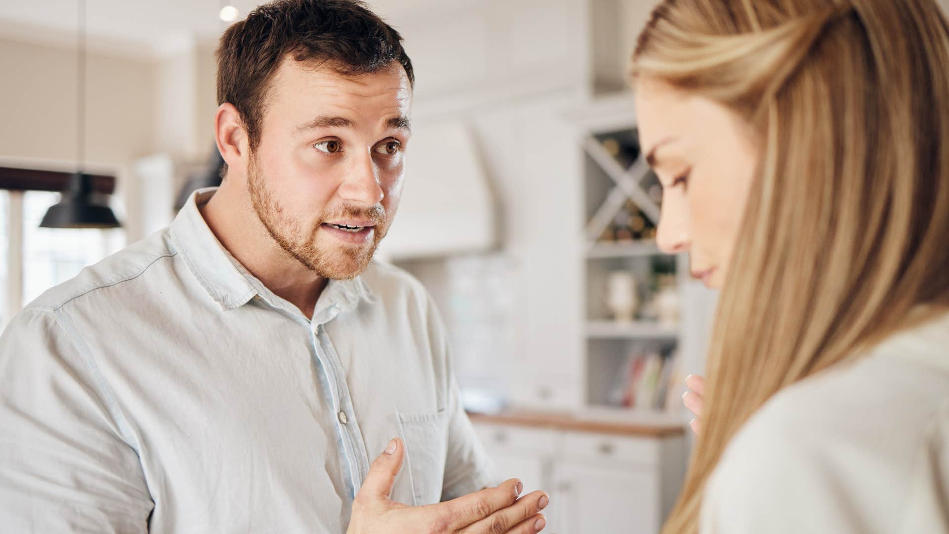 man acting defensively with his upset wife