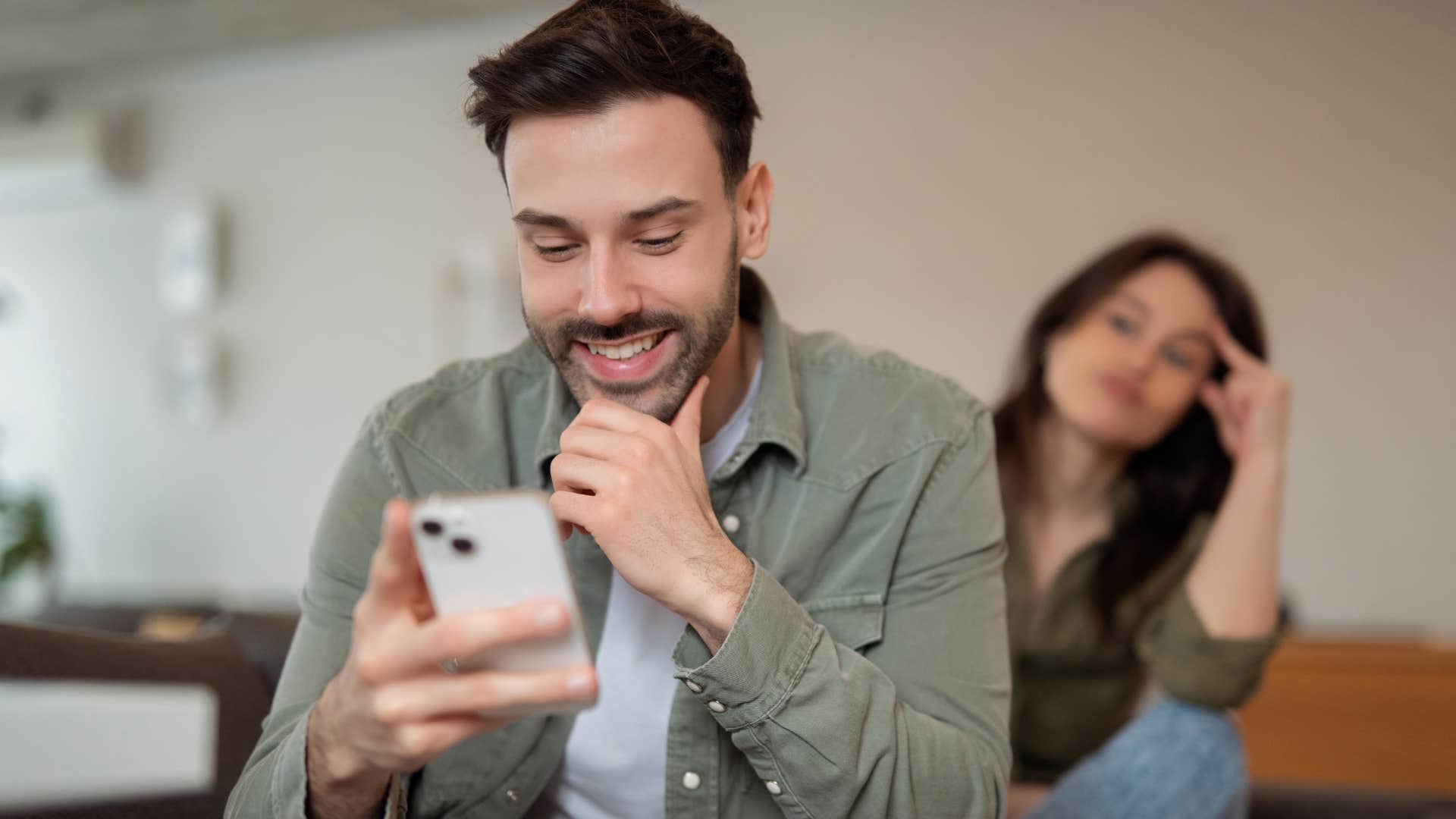 man being distracted and not listening to his wife