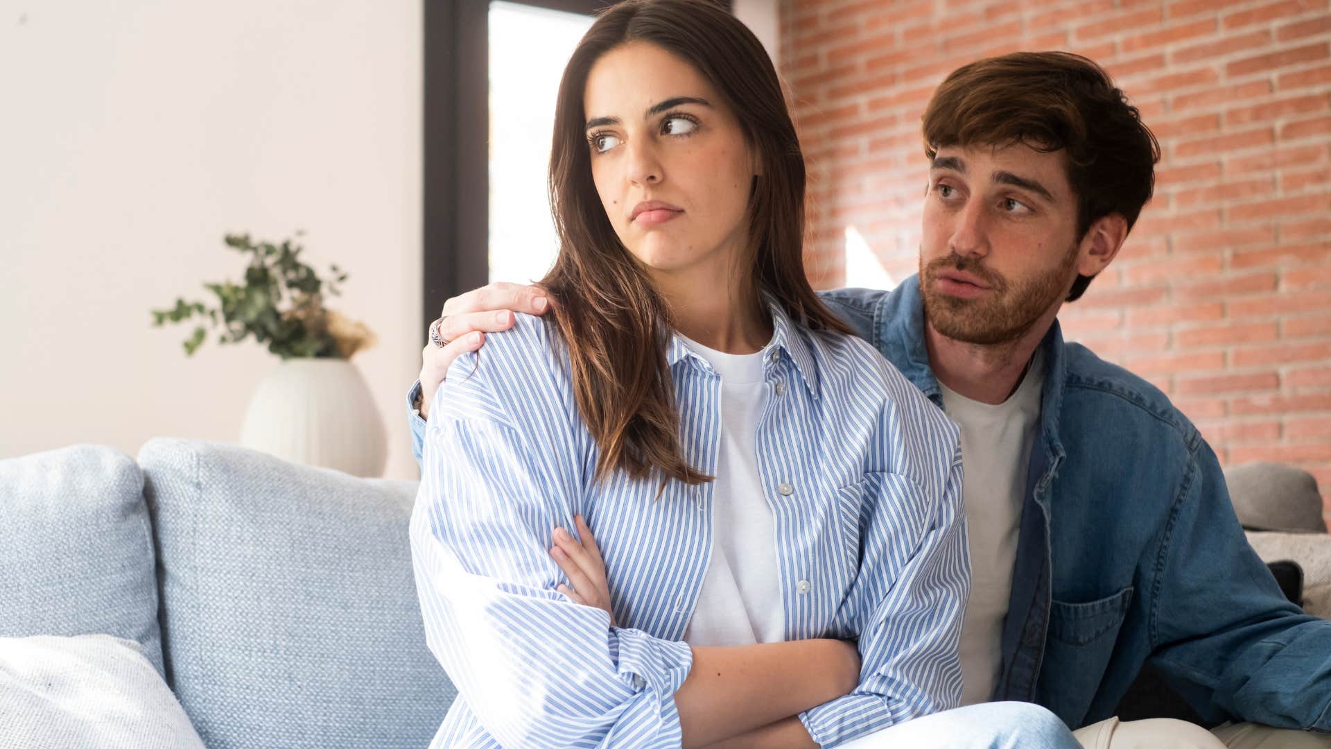 annoyed wife turned away from husband telling him you're so needy