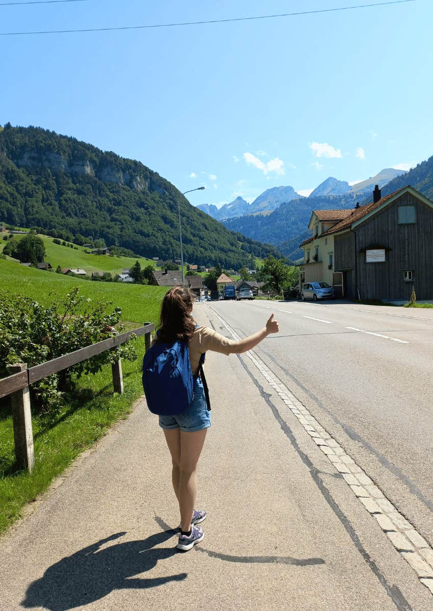 woman with a backpack hitchhiking
