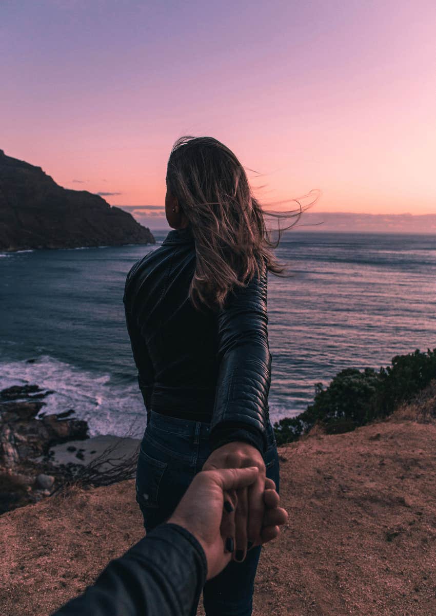 woman leading man towards view