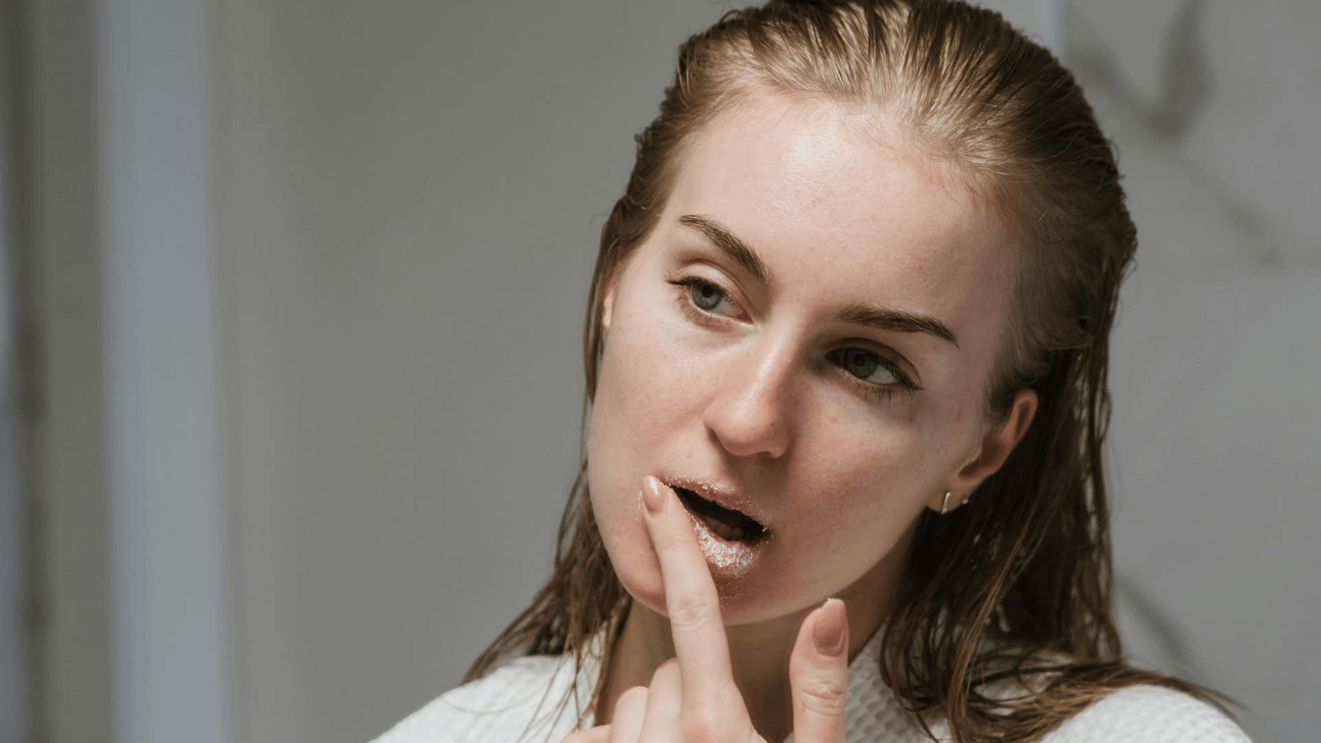 woman making man feel something by exfoliating their lips