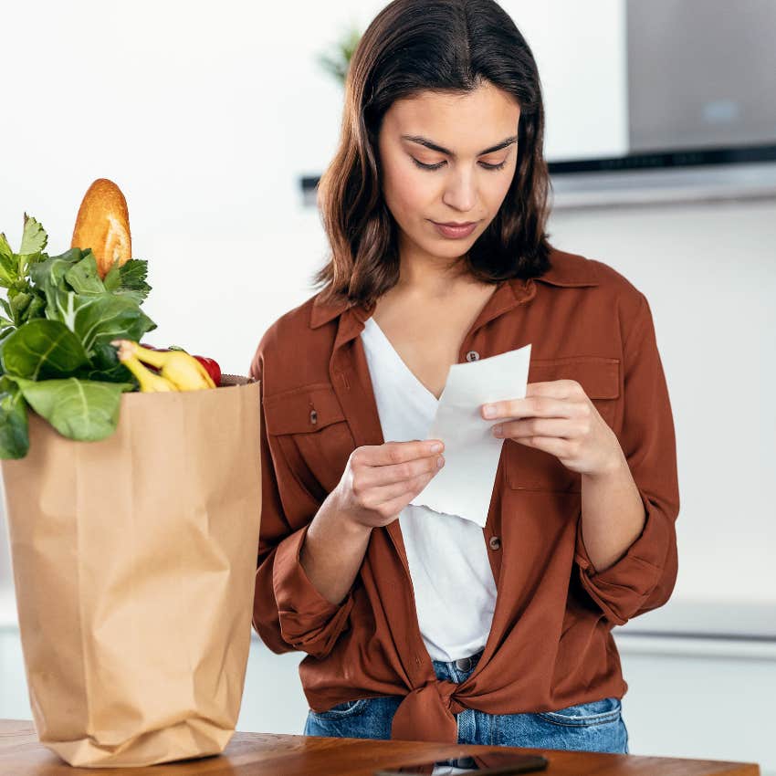 woman checking her receipt after getting Uber Eats delivery 