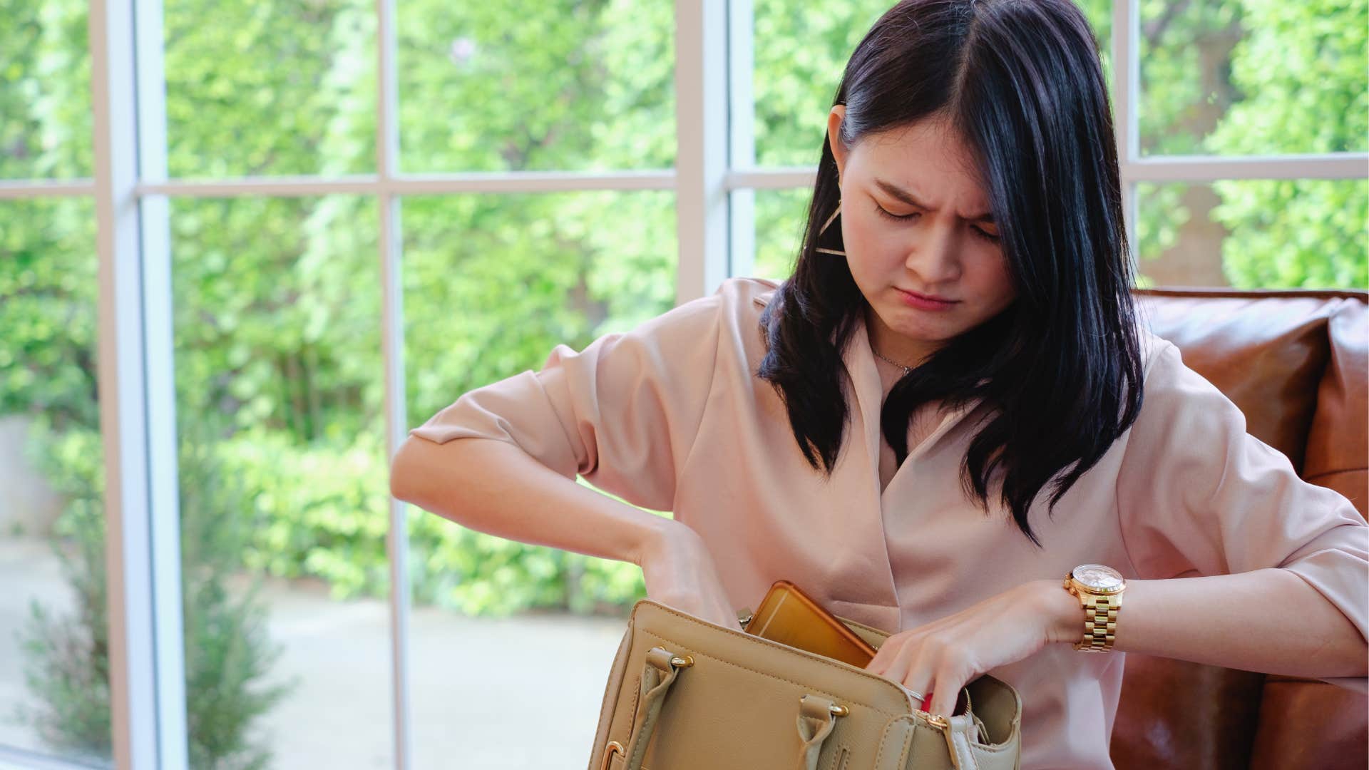Woman who doesn't like uncertainty looking in her purse.