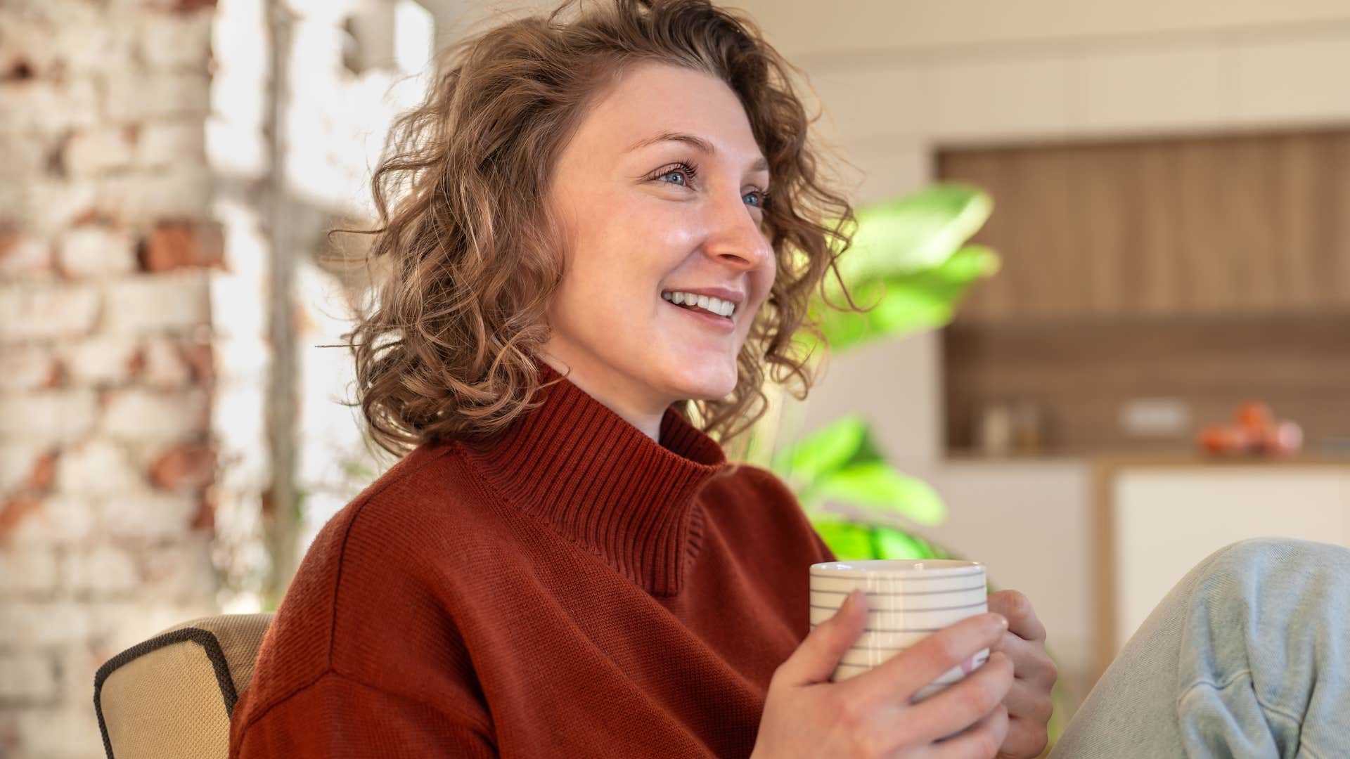 Woman with a strong self-care routine smiling at home.