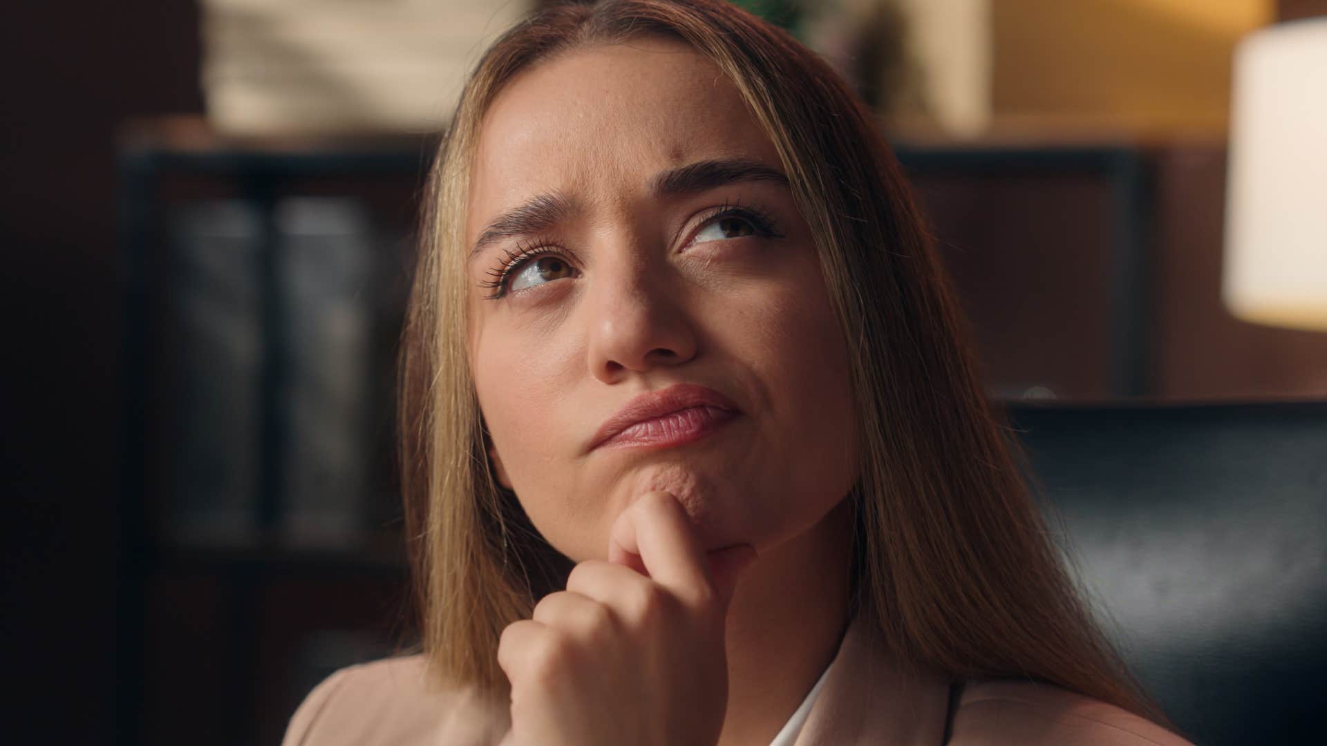 close up of thoughtful woman who avoids asking for help, even when she needs it