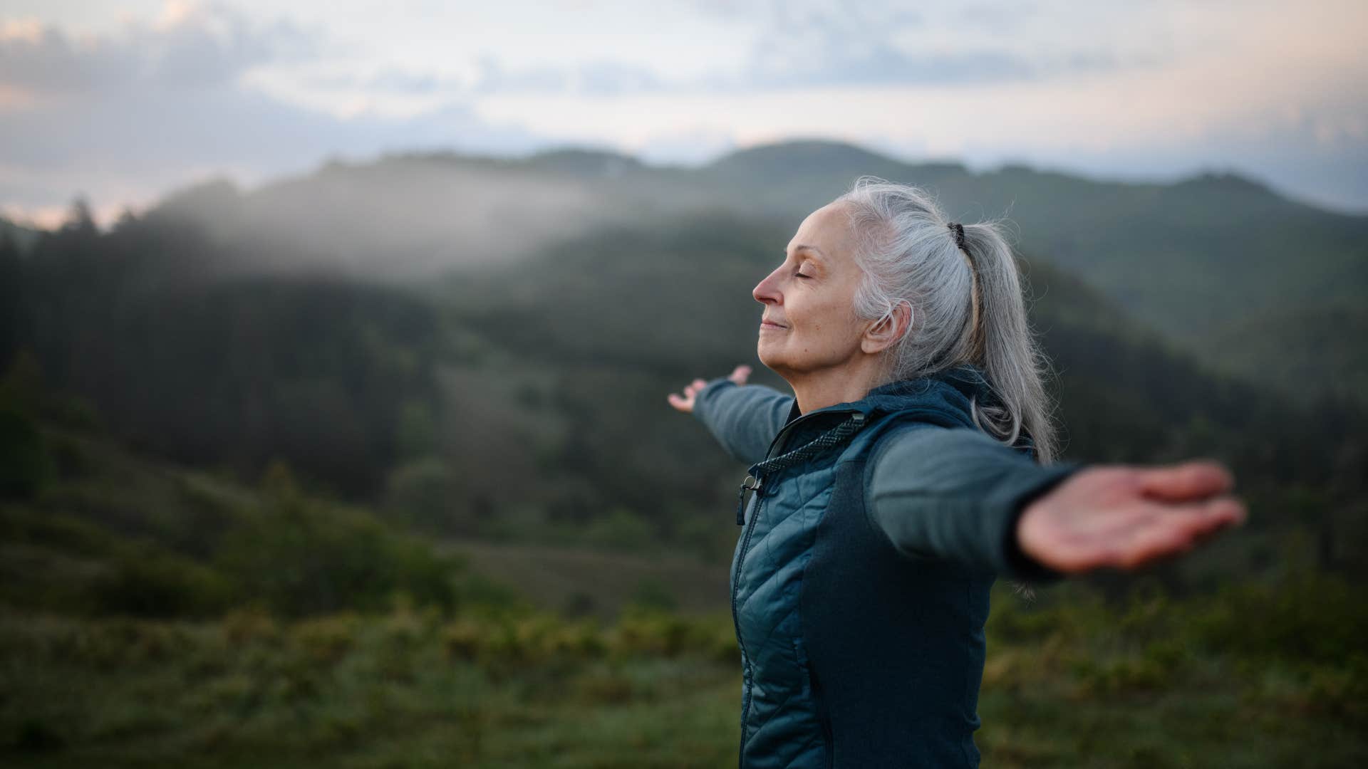 Peaceful woman stretches in nature showing comfortable with self