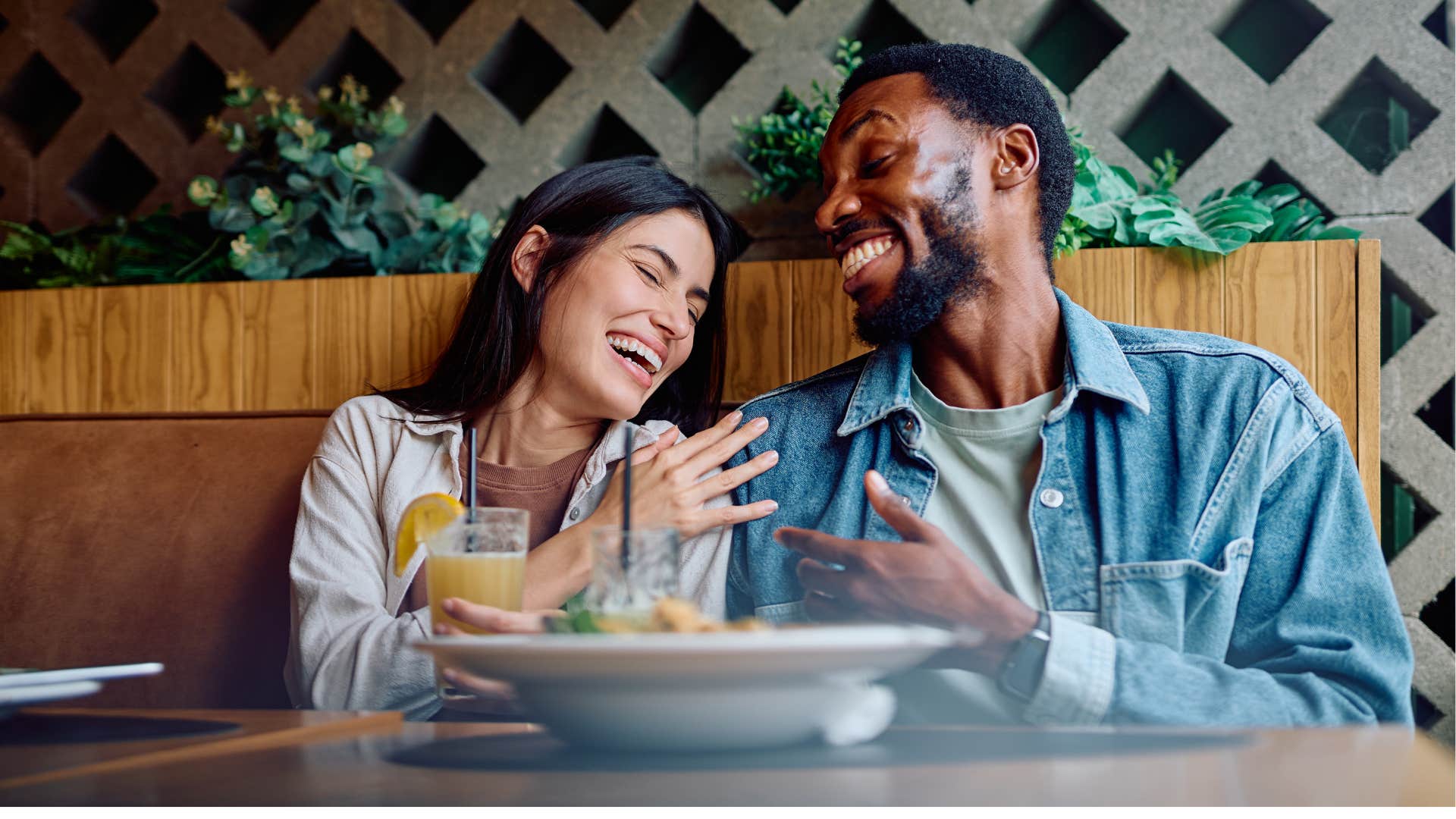 Laughing partners share food showing distinct personality