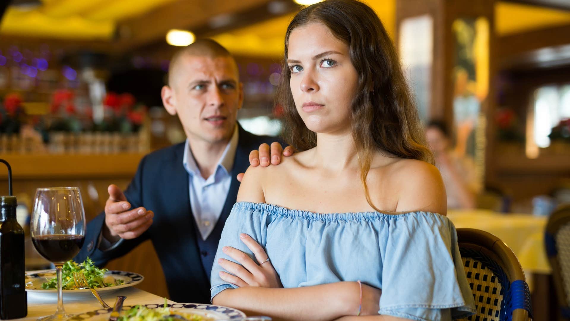 Upset woman turns away from agressive man showing she is more at peace alone
