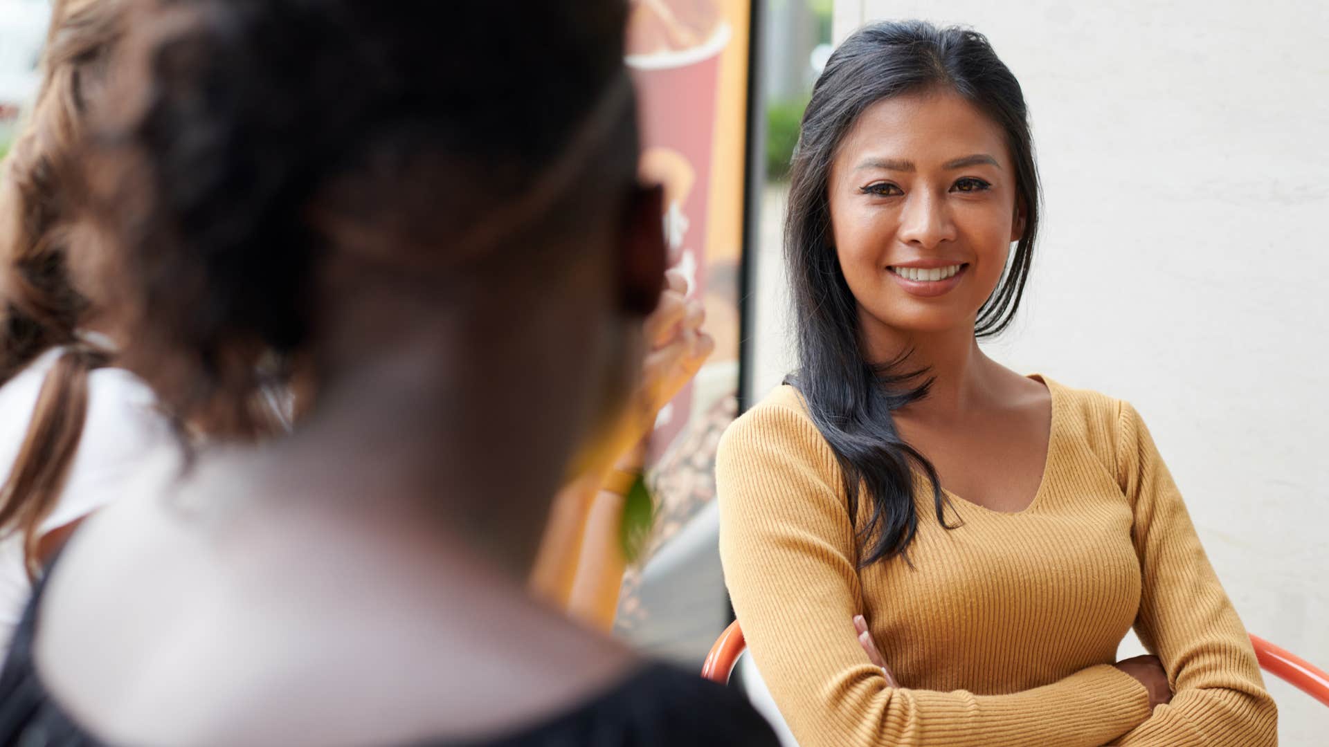Peaceful woman crosses arms showing self reliance 